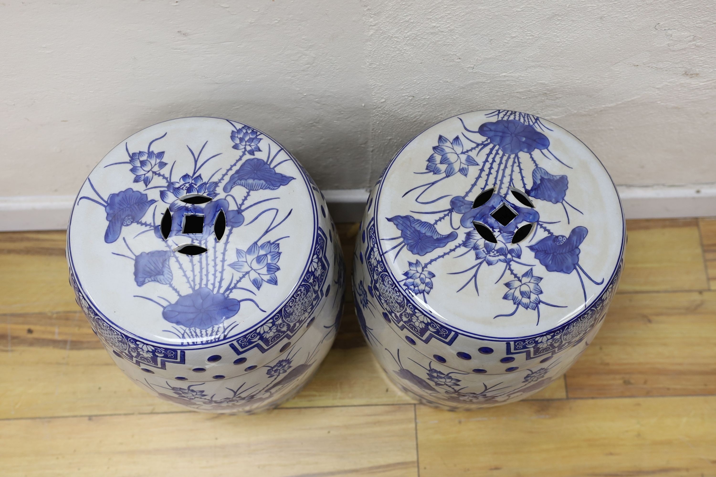 A pair of Chinese blue and white garden seats, 44 cms high.
